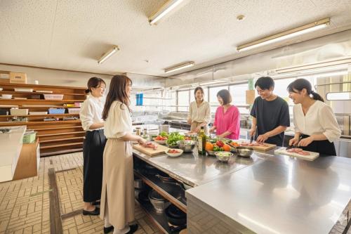 a group of people in a kitchen preparing food at Sea Hale - Vacation STAY 7734 in Yuzawa