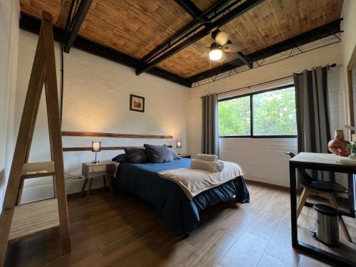 a bedroom with a bed and a large window at Discover Condesa Ideal Location in Mexico City