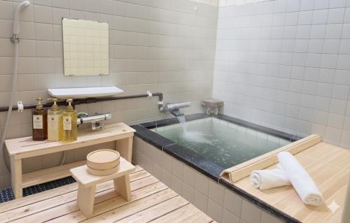 a bathroom with a jacuzzi tub with a mirror at Yuzawa Toyo - Vacation STAY 98053 in Yuzawa