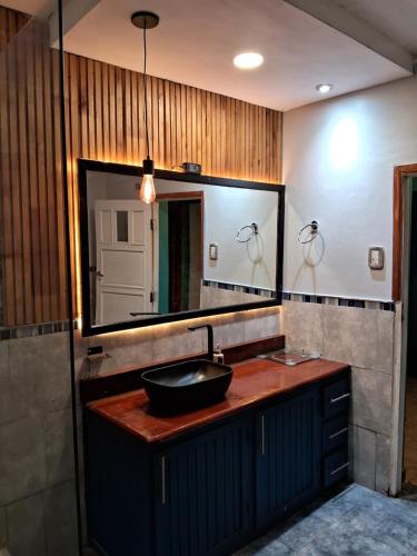 a bathroom with a sink and a large mirror at Casademontaña in Belén