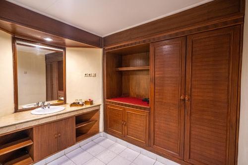 a bathroom with a sink and a mirror at New Sunari Lovina Beach Resort in Lovina