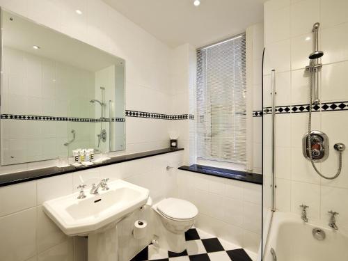 a bathroom with a sink and a toilet and a shower at Mercure Oxford Eastgate Hotel in Oxford
