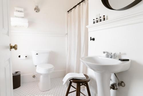 a white bathroom with a sink and a toilet at The Lindsey Hotel in Rockland
