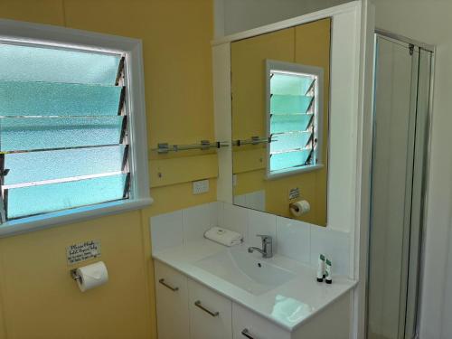 a bathroom with a sink and a mirror at Kooyong Apartments, Arcadia in Arcadia