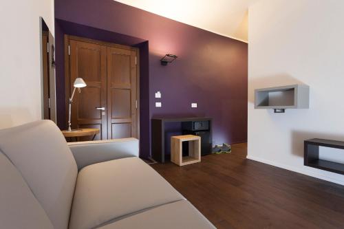a living room with a couch and a fireplace at Casa Alla Lega in Arco
