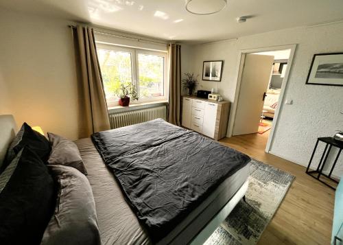 a bedroom with a bed and a window at Garden apartment in Ettlingen