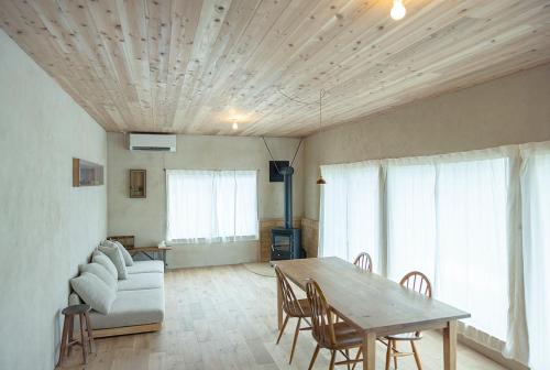 a living room with a table and a couch at matai in Kitsuki
