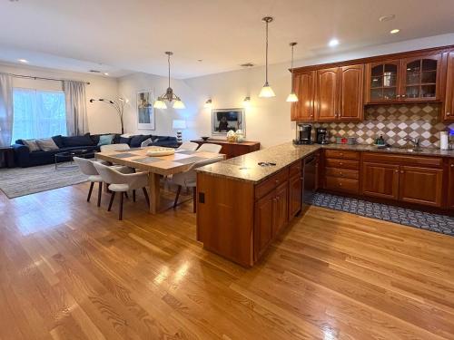 a kitchen and living room with a table and a couch at 3-Bed 2-Bath Brookline Village Townhome w Deck in Brookline