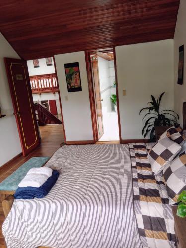 a bedroom with a large bed in a room at Hostal Casalé Usaquén Embajada de Mexico in Bogotá