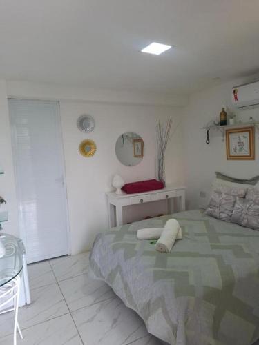 a bedroom with a bed and a table in it at Pousada Brasil Tropical in Bezerros