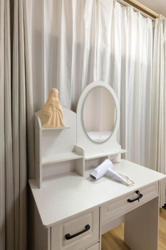 a white dressing table with a mirror on it at Cozy Pad in Tokyo