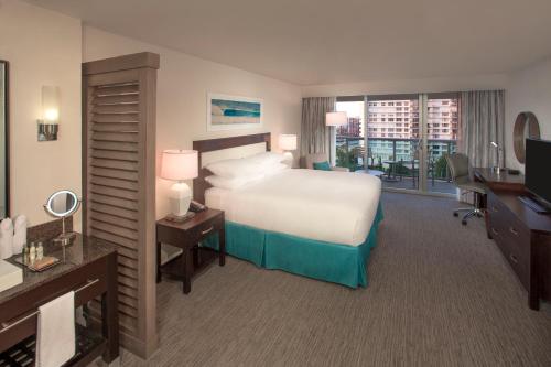 a hotel room with a bed and a desk and a television at DoubleTree Resort by Hilton Hollywood Beach in Hollywood