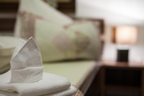 a pile of white towels sitting on top of a couch at Apartman Chopok Juh Ema Superior in Tale