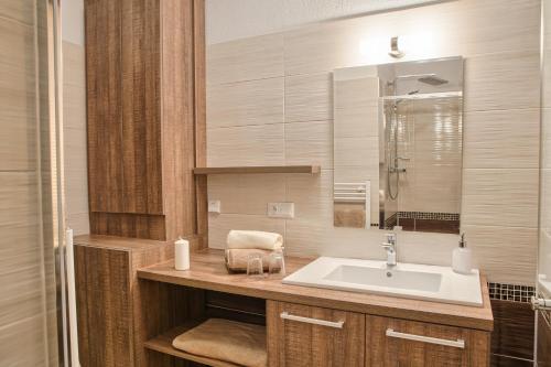 a bathroom with a sink and a mirror at Apartman Chopok Juh Ema Superior in Tale
