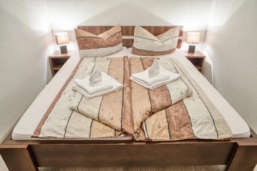a large bed with two pillows on top of it at Apartman Chopok Juh Ema Superior in Tale