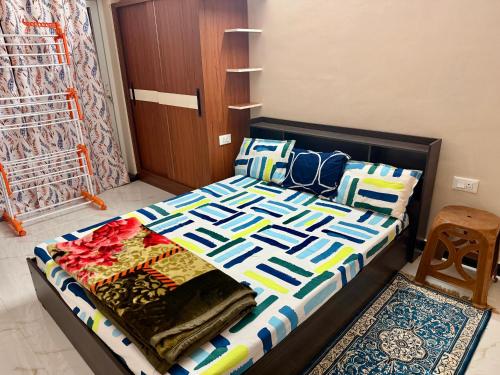 a bedroom with a bed with a colorful comforter at Revival Villa in Coonoor