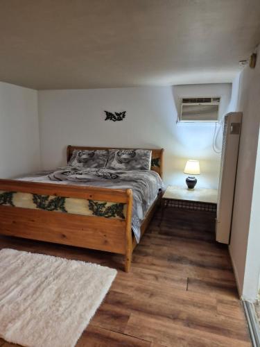 a bedroom with a bed and a lamp on a floor at 66 Motel in Holbrook
