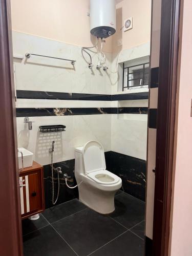 a bathroom with a toilet and a sink at Revival Villa in Coonoor