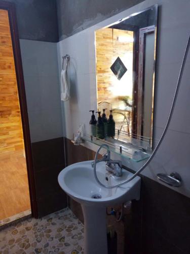 a bathroom with a sink and a mirror at My's Hmong House in Tả Van