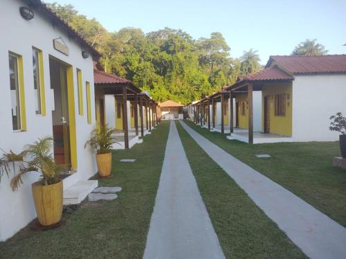 a row of houses with plants in the grass at Pousada Chale Joana in Alter do Chao