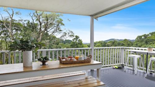 a porch with a table with a basket of fruit at Tree Scape Retreat in Robertson
