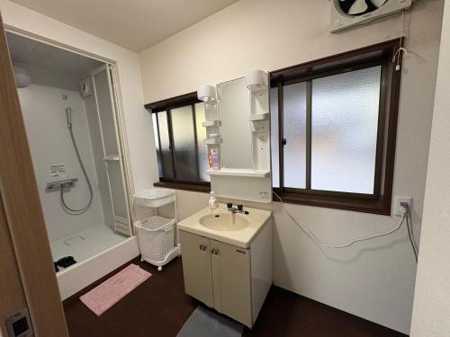 a bathroom with a sink and a shower and a toilet at アパート一室堅田駅徒歩10分貸切要相談 in Otsu