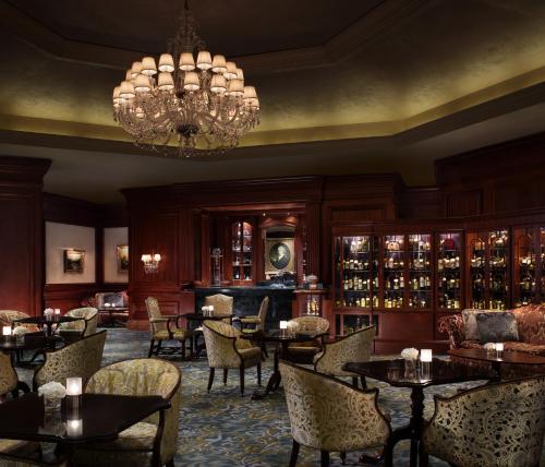 a restaurant with tables and chairs and a chandelier at The Ritz-Carlton Osaka in Osaka