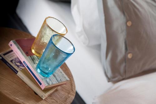 a blue glass on a table next to a bed at Casa Alla Lega in Arco