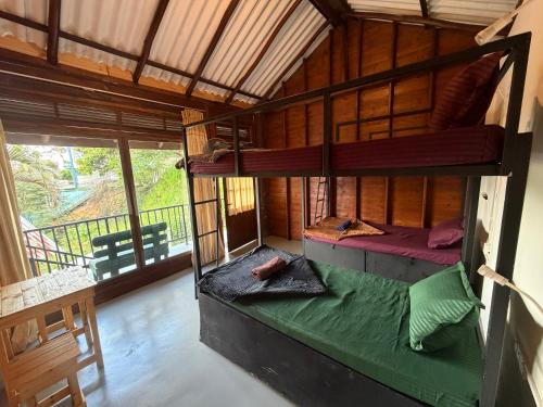 a room with two bunk beds in a house at Okan Rock Hostel Ella in Ella