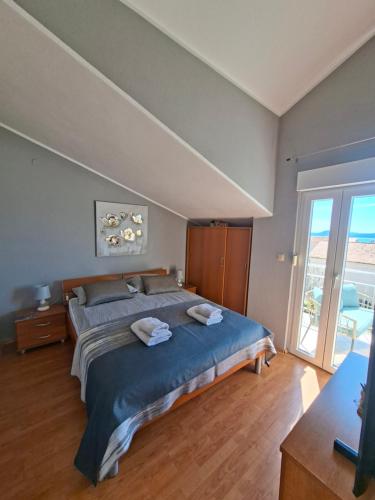 a bedroom with a bed with two towels on it at Villa Neda in Vodice