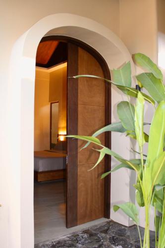 a room with a wooden door with a mirror at Mawari Sanctuary Villa El Nido in El Nido