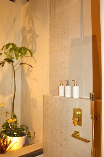 a bathroom with a refrigerator and a plant on a shelf at Mawari Sanctuary Villa El Nido in El Nido
