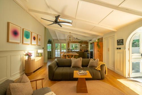 a living room with a couch and a ceiling fan at Vihara - Stunning, Private apartment with private pool in Mullumbimby