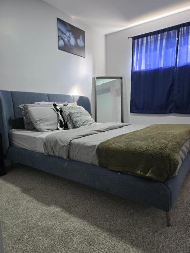 a bedroom with a bed with a mirror and a window at Basement suite in Winnipeg in Winnipeg