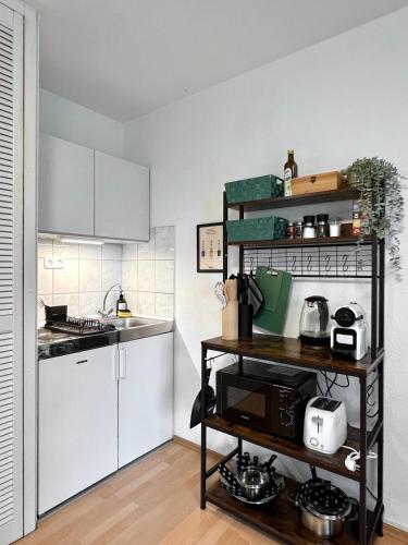 a kitchen with white cabinets and a counter at Modern, Gemütlich mit WLAN, TV in Essen