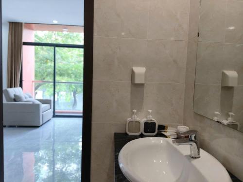 a bathroom with a sink and a mirror at Coast Pearl Hotel in Phú Quốc