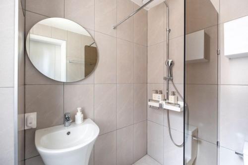 a bathroom with a shower and a sink and a mirror at 남해독일마을드레스덴 in Samhwa-dong