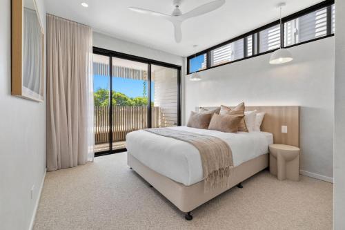 a bedroom with a large bed and a large window at Solis Villa in Pottsville