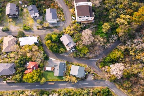 an aerial view of a house with a road at Cozy Villa with Hot springs and Nature in Ito