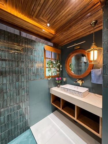 a bathroom with a sink and a mirror at Arcelia Cottage, Cozy Villa in Nainital in Nainital