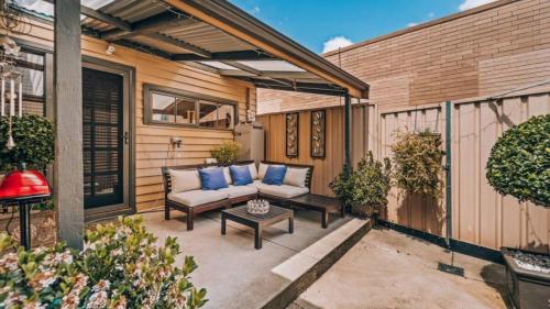a patio with a couch and a coffee table at Family Cottage in Bendigo