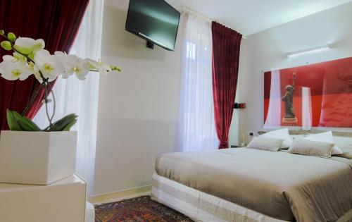ヴェローナにあるItalianflat - Arena di Verona Rensiのベッドルーム1室(ベッド1台、花瓶1本付)
