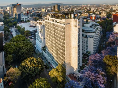 an aerial view of a tall building in a city at Andaz Condesa Mexico City, By Hyatt in Mexico City