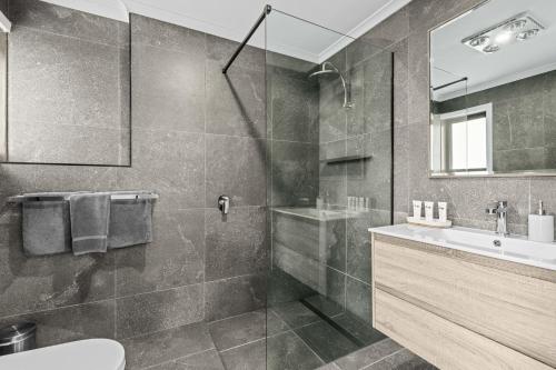 a bathroom with a shower and a sink at Anchor Wheel Motel in St Helens