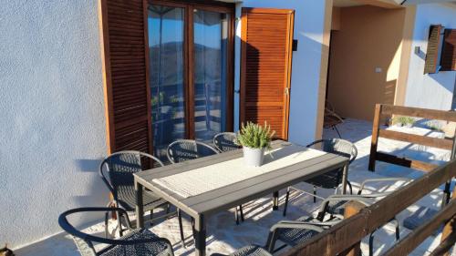 a patio with a table and chairs on a balcony at Peaceful New Country House with Saltwater Pool in Brgud