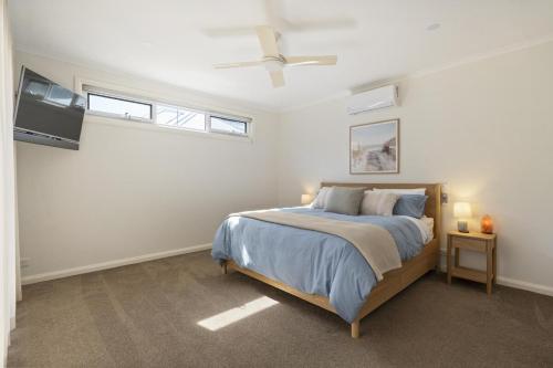 a bedroom with a bed and a flat screen tv at My Place, McCrae in McCrae