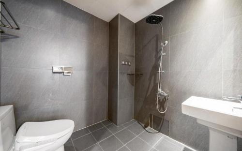 a bathroom with a shower and a toilet and a sink at Daeheung Manwol Hotel in Daejeon