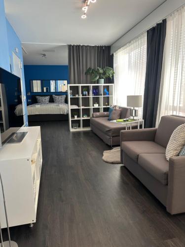 a living room with two couches and a couch and a bedroom at LuganoApartment in Lugano