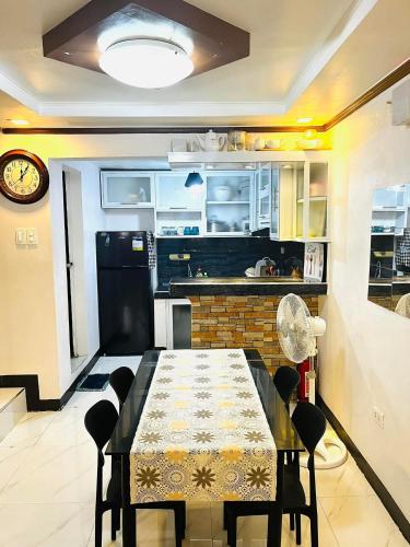 a kitchen and dining room with a table and chairs at Calapan Transient House Xevera in Calapan