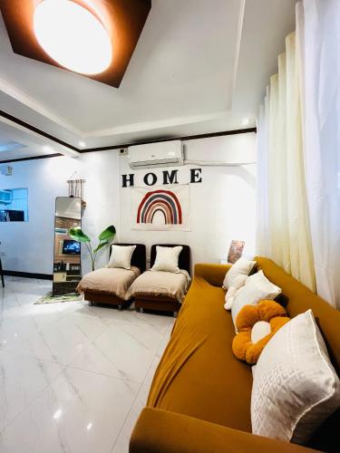 a living room with two couches and a rainbow on the wall at Calapan Transient House Xevera in Calapan